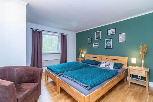 a bedroom with a large bed and a chair at KAL911-Hjorted-Sandekulla in Gissebo