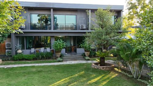 a house with a garden in front of it at Live Specialty House in Ban Wang Pong