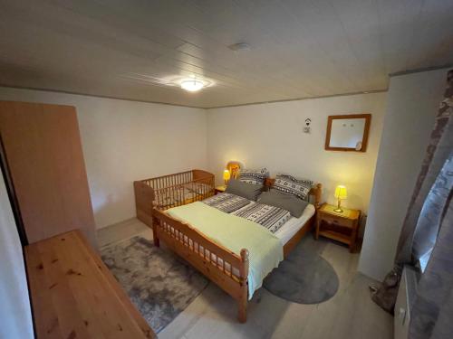 a bedroom with a bed and two night stands at Ferienwohnung I&I in Halsenbach