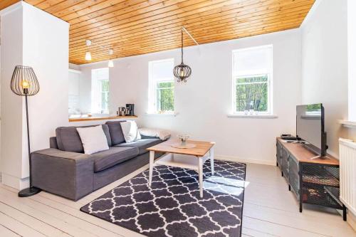 a living room with a couch and a tv at VAR950-Hagfors-Knoaende-13 in Hagfors