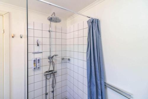 a shower with a blue shower curtain in a bathroom at VAR949-Hagfors-Knoaende-11 in Hagfors