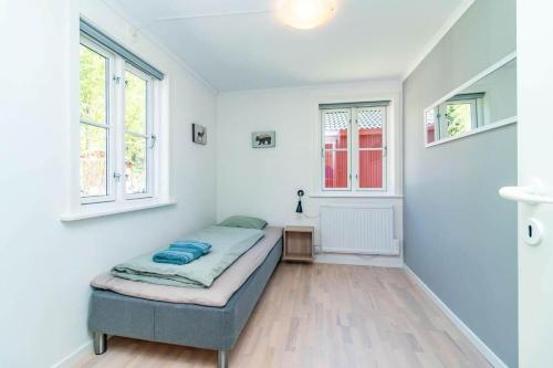 a bedroom with a bed and two windows at VAR949-Hagfors-Knoaende-11 in Hagfors