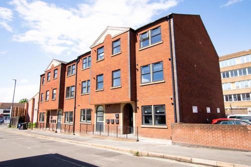 a brick building on the side of a street at Derwent Court Aparthotel in Derby