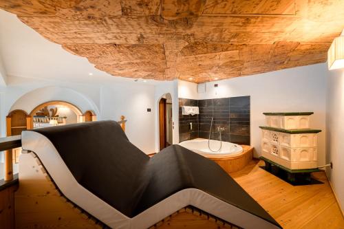 a large bathroom with a tub and a sink at Croce Bianca Leisure & Spa Hotel in Canazei