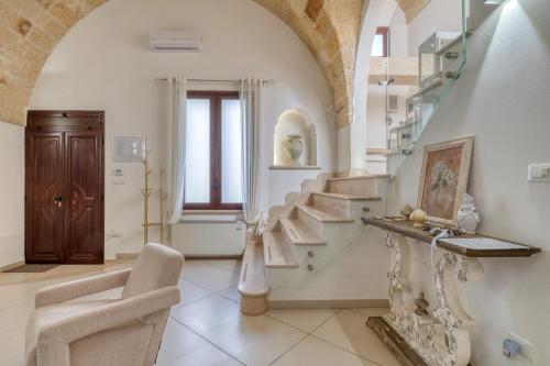 a living room with stairs and a stair case at Volta Apartment in Mesagne