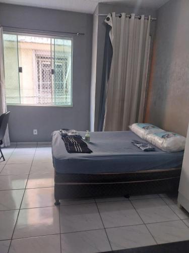 a bed in a room with a window at KITNET ELVIS PRESLEY - Largo do Machado in Rio de Janeiro