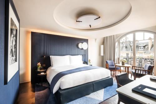 a hotel room with a bed and a table and chairs at Mandarin Oriental Lutetia, Paris in Paris