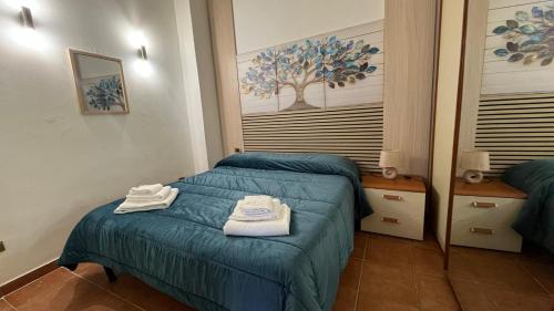 a bedroom with a bed with towels on it at HeraDea in Crotone