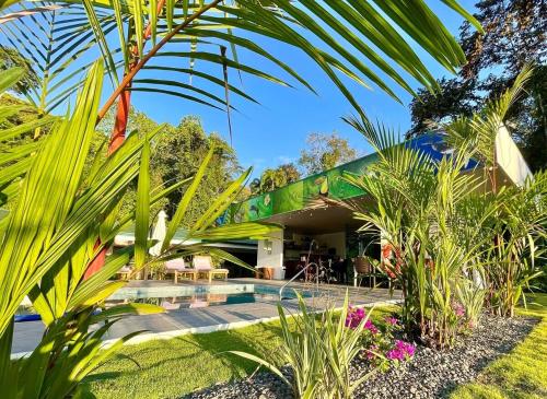 a house with a swimming pool and some plants at Luxury Apartments Nauyaca by Paradiselodge in Platanillo