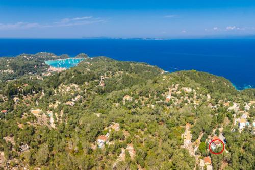 an aerial view of a hill with houses and the ocean at Dimitris Cottage in Apergátika