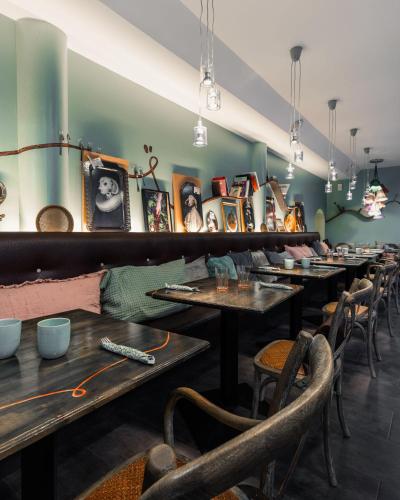 a row of tables and chairs in a restaurant at Hôtel La Demeure in Guingamp