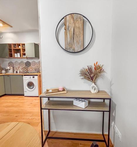 a room with a table and a mirror on the wall at Douceur de Vivre à Vichy, T1B, Cosy& Lumineux, 4p in Vichy
