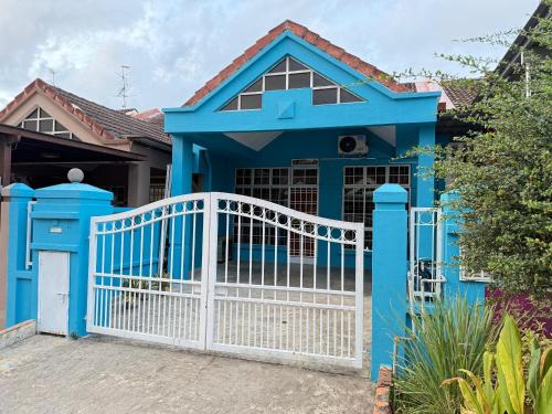 a blue house with a white gate at J&N Homestay in Skudai