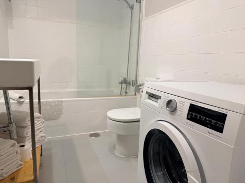 a white bathroom with a washing machine in it at Smartmonki Sinagoga Entre la Catedral y Zocodover in Toledo