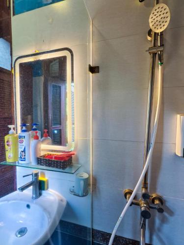 a bathroom with a sink and a mirror at Xumi Motel in Hanoi