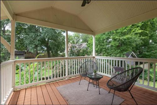 a screened porch with two chairs and a table at Harvest Moon in Atlanta