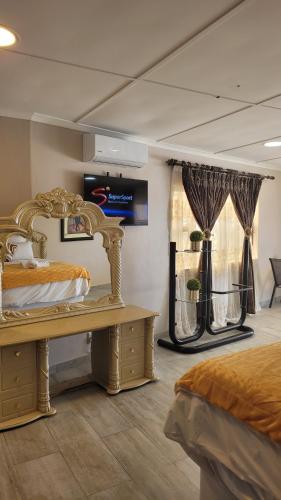 a bedroom with two beds and a window with curtains at Sharks View in Port Shepstone