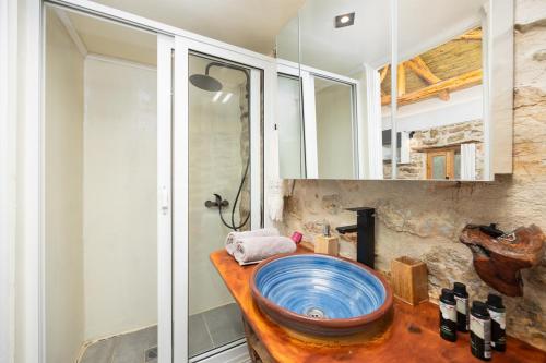 a bathroom with a large blue sink on a counter at Villa Liana in Petalidi