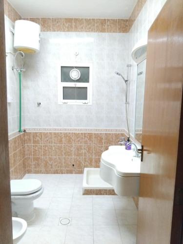 a bathroom with a toilet and a sink at DIAMANTE Al Ain - 10 in Al Ain