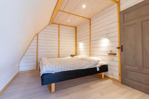 a small bedroom with a bed in a attic at KRO845-Lessebo-Vedamala-14 in Ljuder