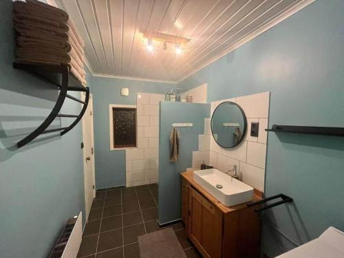 a bathroom with a sink and a mirror at NOR118-Junosuando-Keraentoejaervi-81 in Junosuando