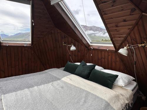 a bedroom with a bed in a room with two windows at Igloo-Dome by a River - Sky Sighting - Glamping in Litli-Árskógssandur