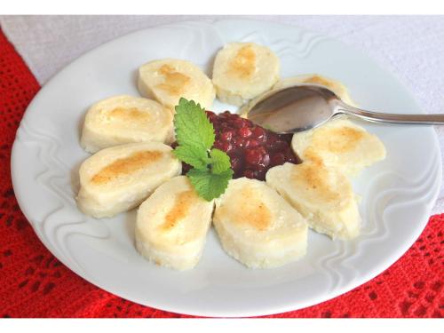 a plate of bananas and berries with a spoon at Turistična kmetija Stoglej in Luče