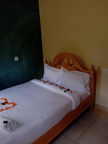 a bed with a wooden headboard with decorations on it at Longonot View Camp and Accommodation, Naivasha in Naivasha