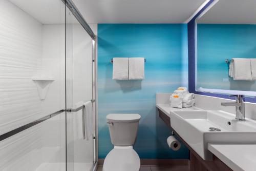 a bathroom with a toilet and a sink and a mirror at Captain's Quarters Resort in Myrtle Beach