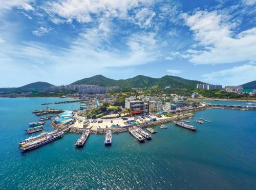 an aerial view of a harbor with boats in the water at Onda D'oro Hostel in Yeosu