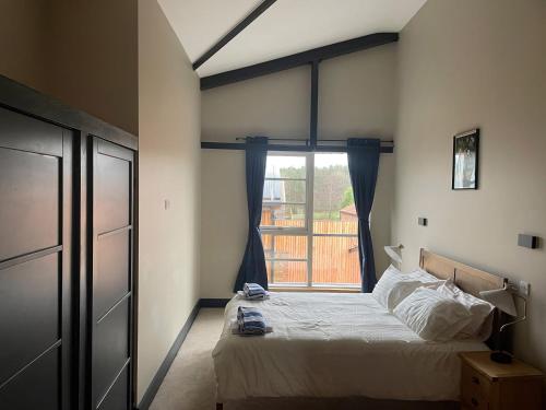 a bedroom with a bed and a large window at Spring Meadow in Durham