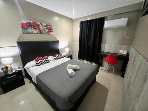 En eller flere senge i et værelse på Hotel La Terminal