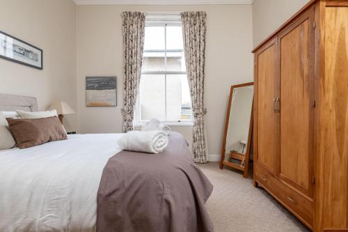 a bedroom with a large bed and a window at St Albans Lower - Elie in Earlsferry