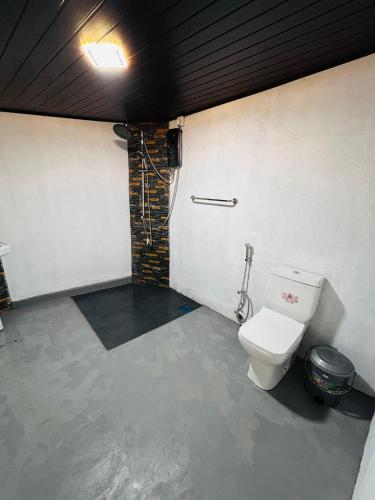 a bathroom with a toilet in a room at Coconut Tree hill Rekawa in Tangalle