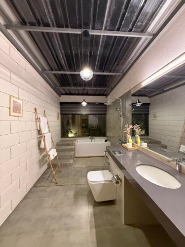 a bathroom with two sinks and a bath tub at Chaparrals Surf in Dickwella
