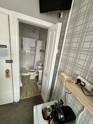 a small bathroom with a toilet and a sink at Belvedere - Adults Only in Blackpool