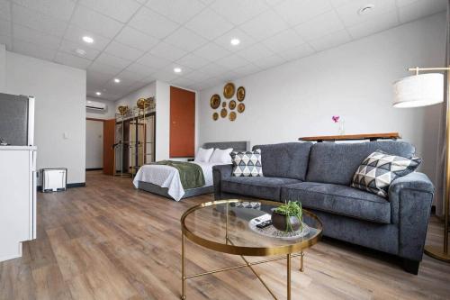 a living room with a couch and a table at Golden Hour @TheMillRowsSuites in New Glasgow
