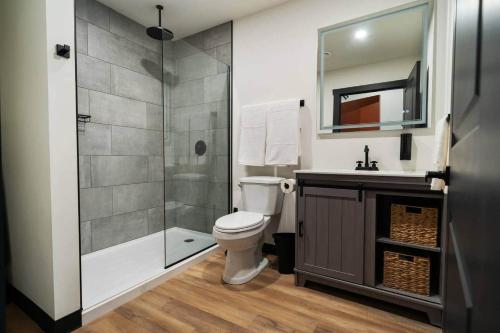 a bathroom with a shower and a toilet and a sink at Game Night @ The MillRows Suites in New Glasgow