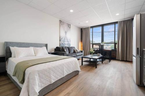 a bedroom with a large bed and a living room at Game Night @ The MillRows Suites in New Glasgow