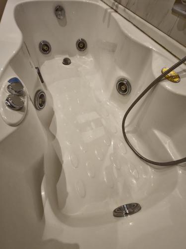 a white bath tub with a hose in it at Le Caravelle in Mestre