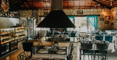 a restaurant with a table and chairs in a room at Güneş' te Karavan Otel in Karaburun