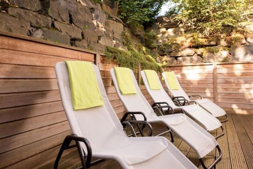 a row of white chairs with yellow towels on them at Maifeld Sport- und Tagungshotel in Werl