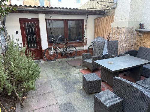 a patio with a table and chairs and a bike at M-Suites - Near Frankfurt Airport in Hattersheim