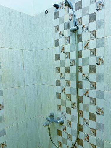 a shower with a glass door in a bathroom at Bandung CoStay in Bandung