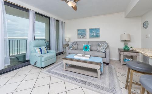 a living room with a couch and a table at Island Winds West 777 in Gulf Shores