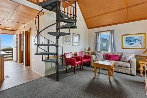 a spiral staircase in the living room of a house at 4060 - Foxhole in Kitty Hawk Beach