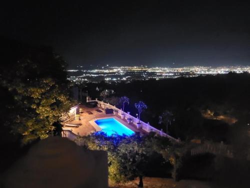 a house with a swimming pool at night at Bronlara in Alhaurín de la Torre