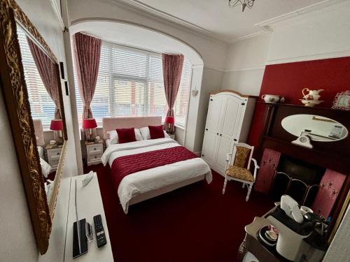 a bedroom with a bed and a mirror at Belvedere - Adults Only in Blackpool