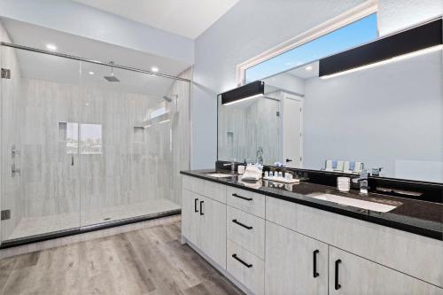 een badkamer met douche en grote spiegel bij Villa Stella in Burnt Store Marina