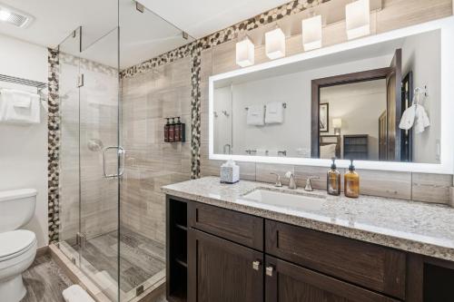 a bathroom with a shower and a sink and a toilet at Lift House Lodge, Pet Friendly, Premium Studio Condo in Vail